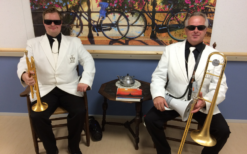 V.I.P. Dixieland Orkest in stijlvolle outfits speelt vrolijke dixielandmuziek tijdens een feestelijk evenement, met een energieke en gezellige sfeer.