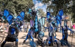 Draken steltenlopers tijdens grote draken parade met fantasie figuren op festival of evenement.