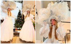 White Cirque C20 steltenlopers in elegante witte hoepelrokken met grote verenhoofdtooien tijdens een winterevenement.