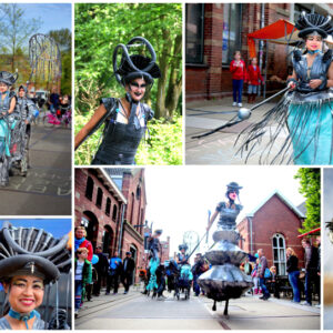 Re-Cycle Parade met steltenlopers en kostuums van gerecyclede materialen tijdens een duurzaam evenement