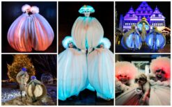 Grote witte sneeuwballen met LED verlichting en performers tijdens een winterse straattheater act